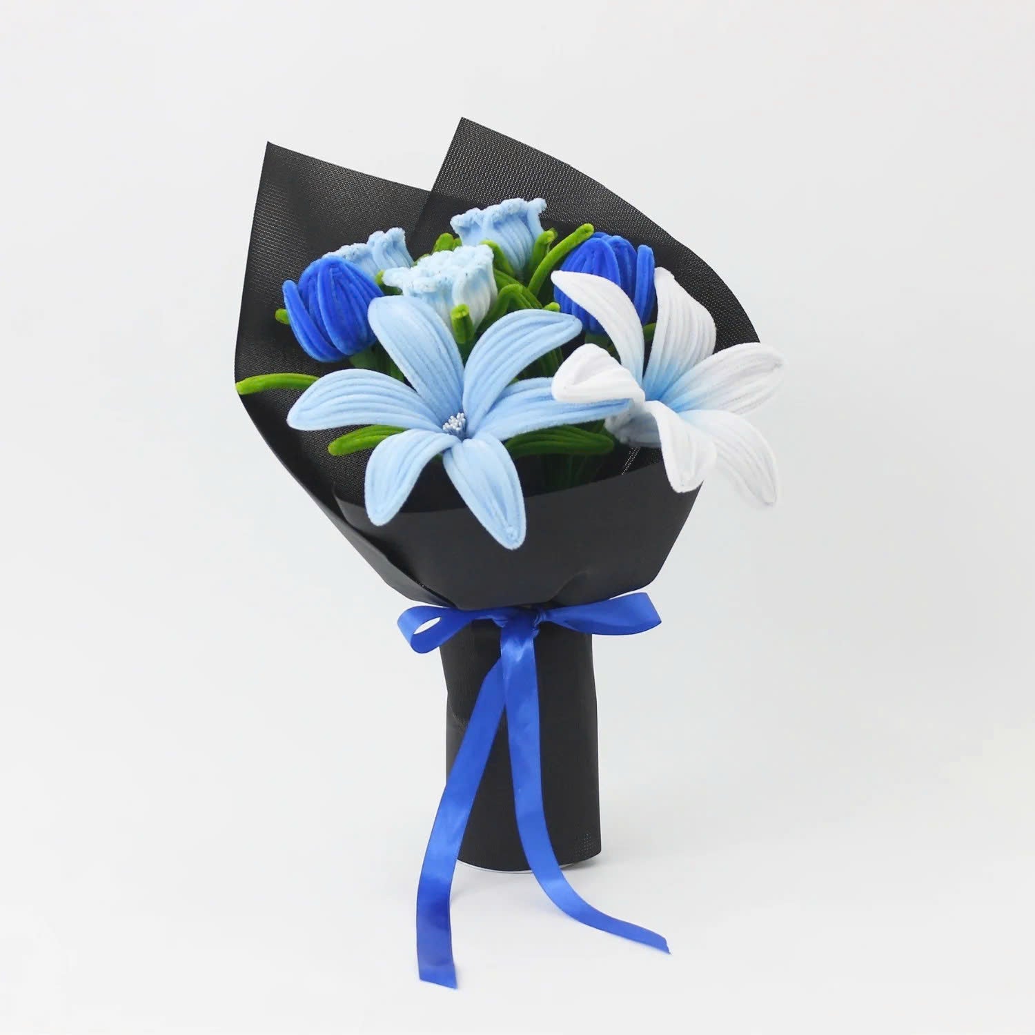 Bluence DIY bouquet featuring blue, white, and light blue lilies made from pipe cleaners, wrapped in sleek black paper with a royal blue ribbon.