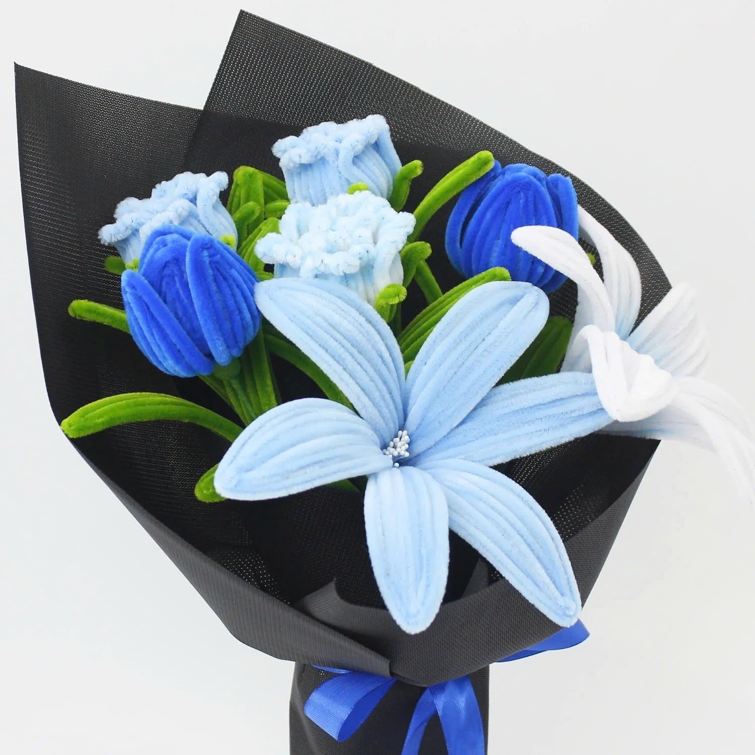 Bluence DIY bouquet featuring blue, white, and light blue lilies made from pipe cleaners, wrapped in sleek black paper with a royal blue ribbon.