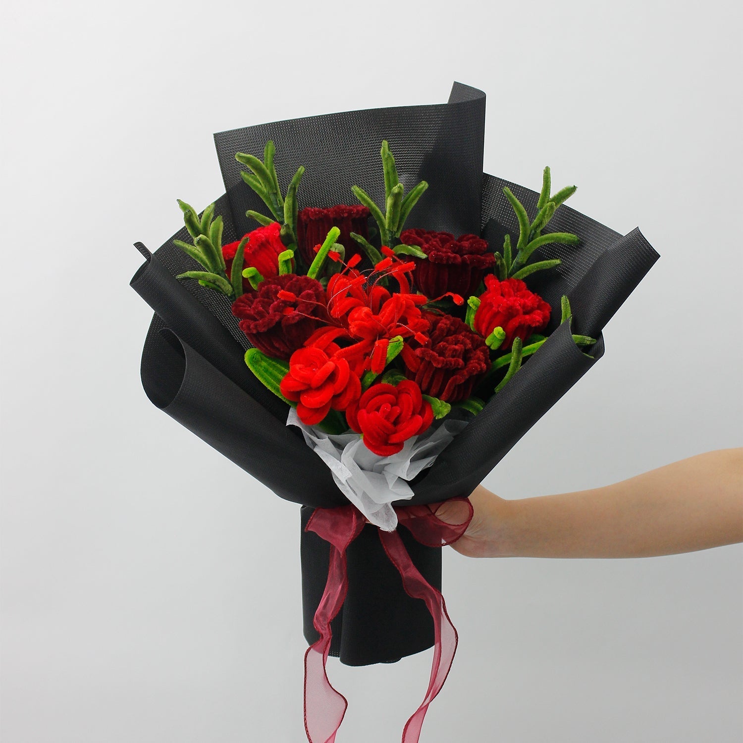 Orange Sunflower DIY bouquet featuring vibrant orange sunflowers and small white daisies made from pipe cleaners, wrapped in kraft and pastel paper with a black ribbon.