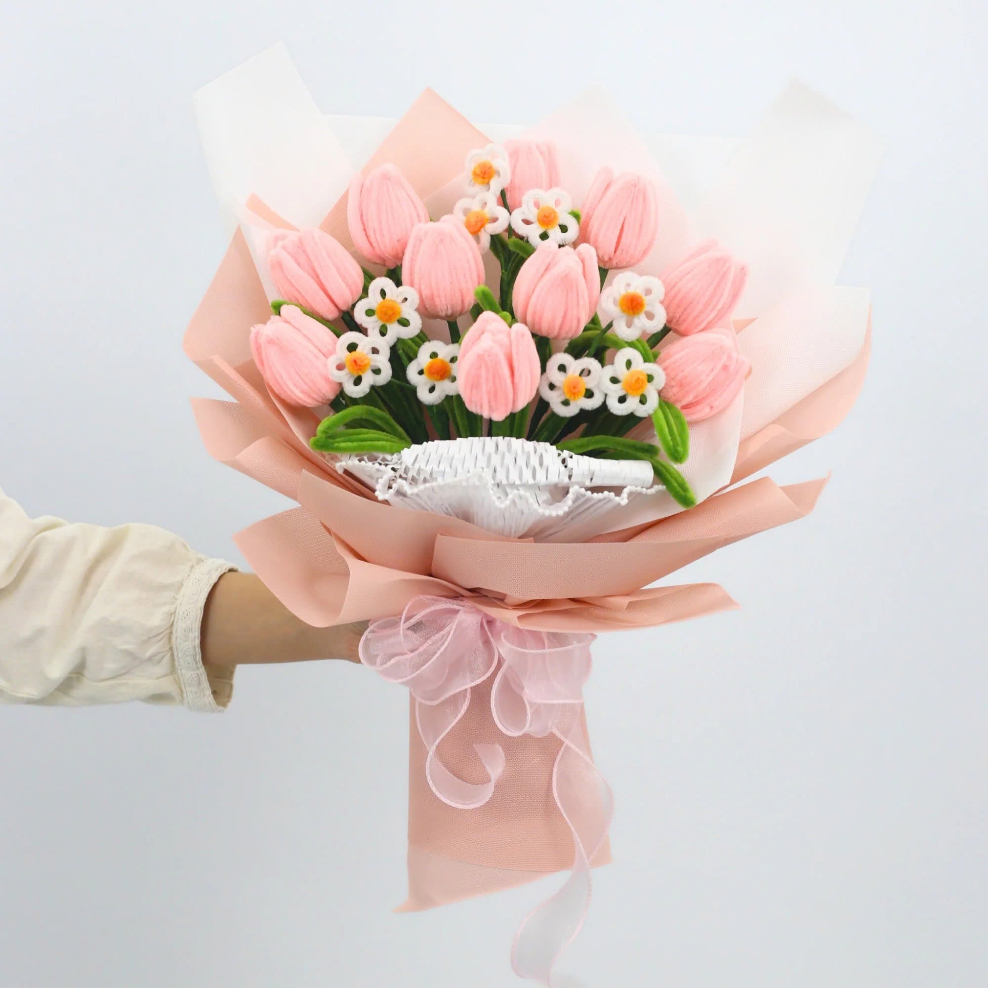 Sweet Blossoms DIY bouquet featuring soft pink tulips and white daisies made from pipe cleaners, wrapped in blush pink paper with a sheer ribbon.
